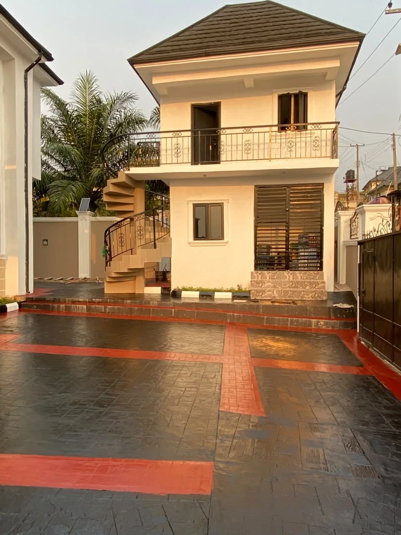 Two-storey adjoining building and curved exterior staircase