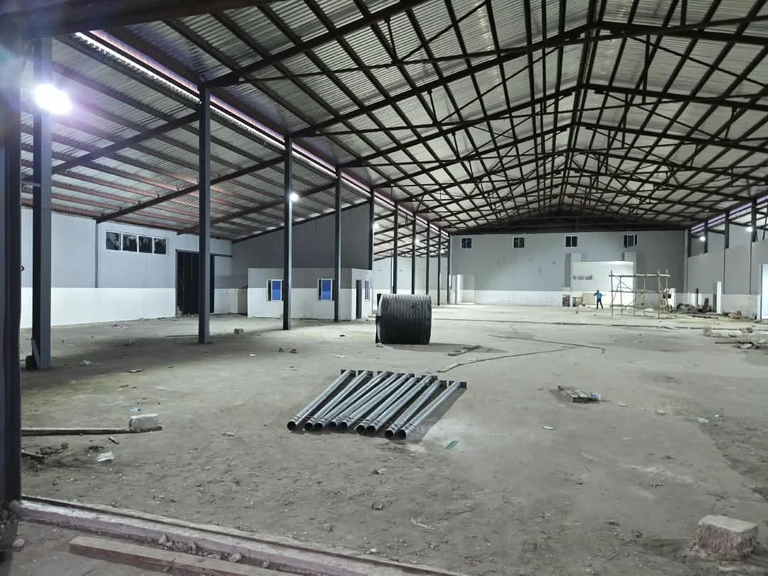 Large factory interior with roof and wall improvements in progress