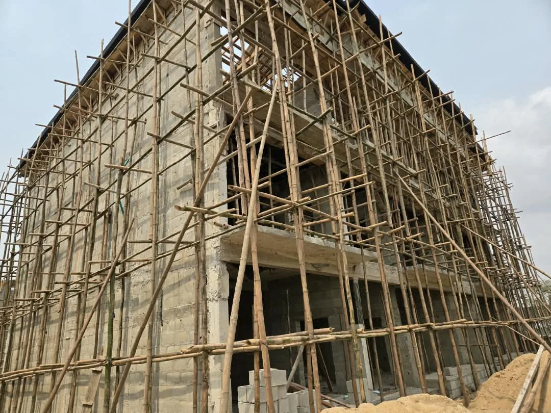 Large building wrapped in bamboo scaffolding