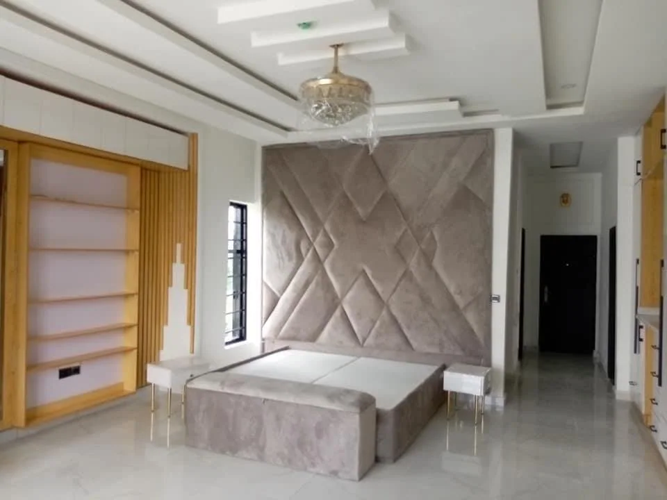 Finished bedroom with upholstered feature wall